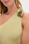 Woman wearing Leek Green Ecos One Piece, a classic, effortless swimsuit with a single shoulder strap featuring a 3D floral detail, reflecting high-end, fun elegance.