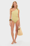 Model wearing the Leek Green Ecos One Piece swimsuit with a classic one-shoulder design, featuring effortless floral detailing, an asymmetric open back, and fun ruching.
