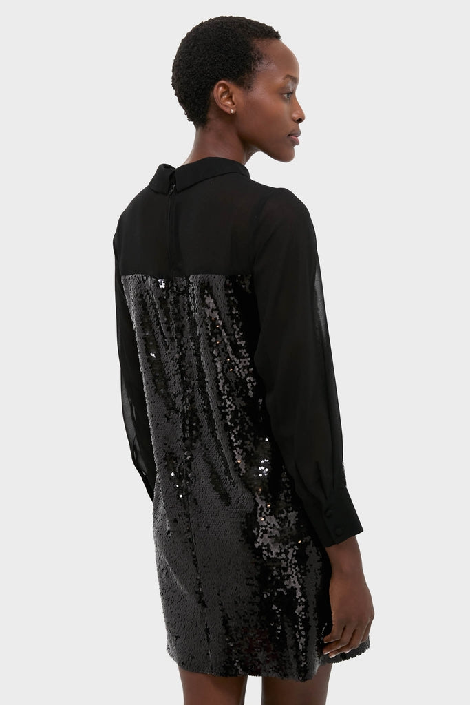 Model wears the Black Sequin Josie Dress, featuring a sheer collared top and sequin body, embodying classic high-end style with an effortless, fun twist.