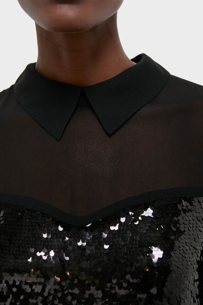 Close-up of the Black Sequin Josie Dress, showcasing its classic pointed collar, sheer mesh yoke, and densely sequined bodice, exuding an effortless and fun high-end style.