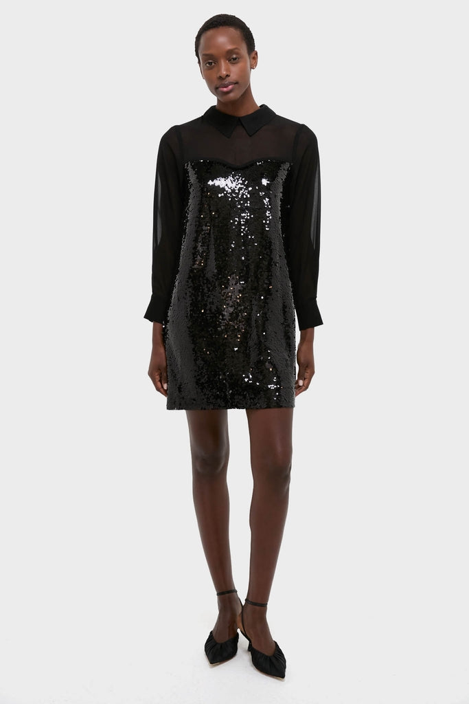 Person wearing the Black Sequin Josie Dress, a classic and high-end shift with a sheer chiffon top, paired with point-toed heels for an effortless and fun look.
