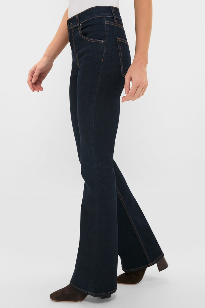 Indigo Resin Bond Street Jean modeled with classic flared silhouette, mid-rise, and contrast stitching, paired effortlessly with brown ankle boots for a fun, high-end look.