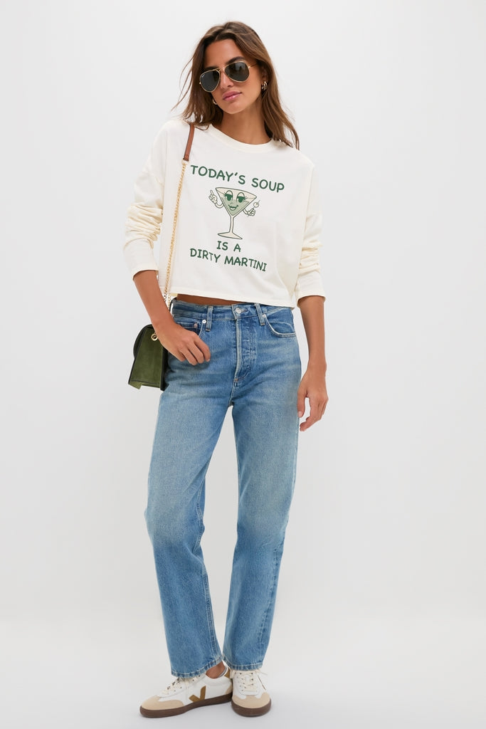 Woman in a Martini Soup Crop Long Sleeve Tee, paired with classic high-waisted jeans and aviators, exudes an effortless, fun, high-end vibe.