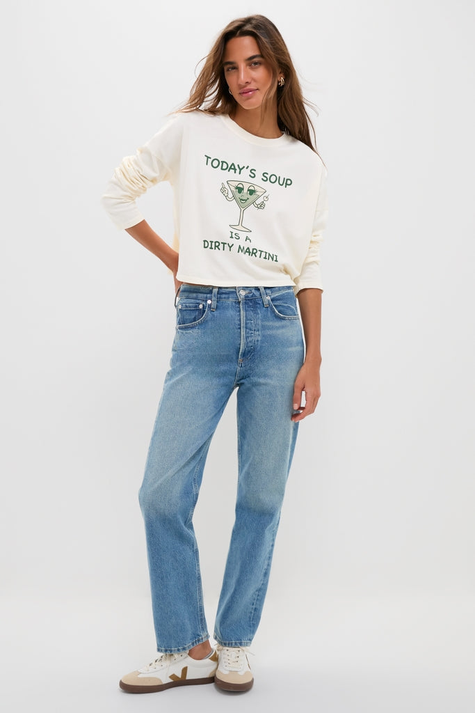 Model in a classic Martini Soup Crop Long Sleeve Tee, embodying effortless style with fun cartoon print, paired with high-end denim by Tuckernuck.