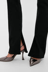 Immersion Ingram Split Skinny pants with a classic hem slit, paired with high-end metallic slingback heels, embodying an effortless and fun style for confident wear.