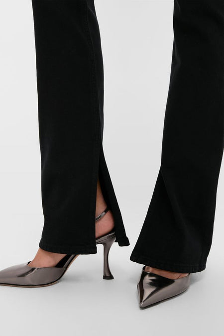 Immersion Ingram Split Skinny pants with a classic hem slit, paired with high-end metallic slingback heels, embodying an effortless and fun style for confident wear.