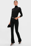 Model in classic Immersion Ingram Split Skinny pants, styled with a fitted turtleneck, metallic pumps, and a clutch, exuding effortless, high-end fashion.