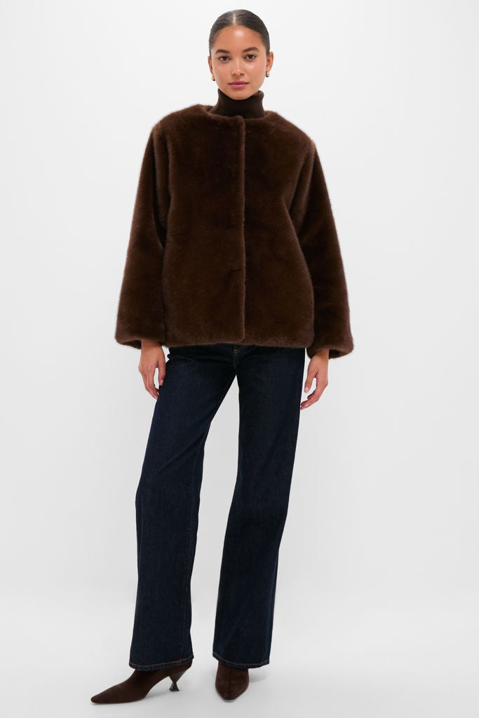Person modeling the classic Dark Brown Faux Fur Brooke Cardigan, featuring a detachable collar and side pockets, styled with indigo jeans and kitten-heel boots for an effortless, high-end look.