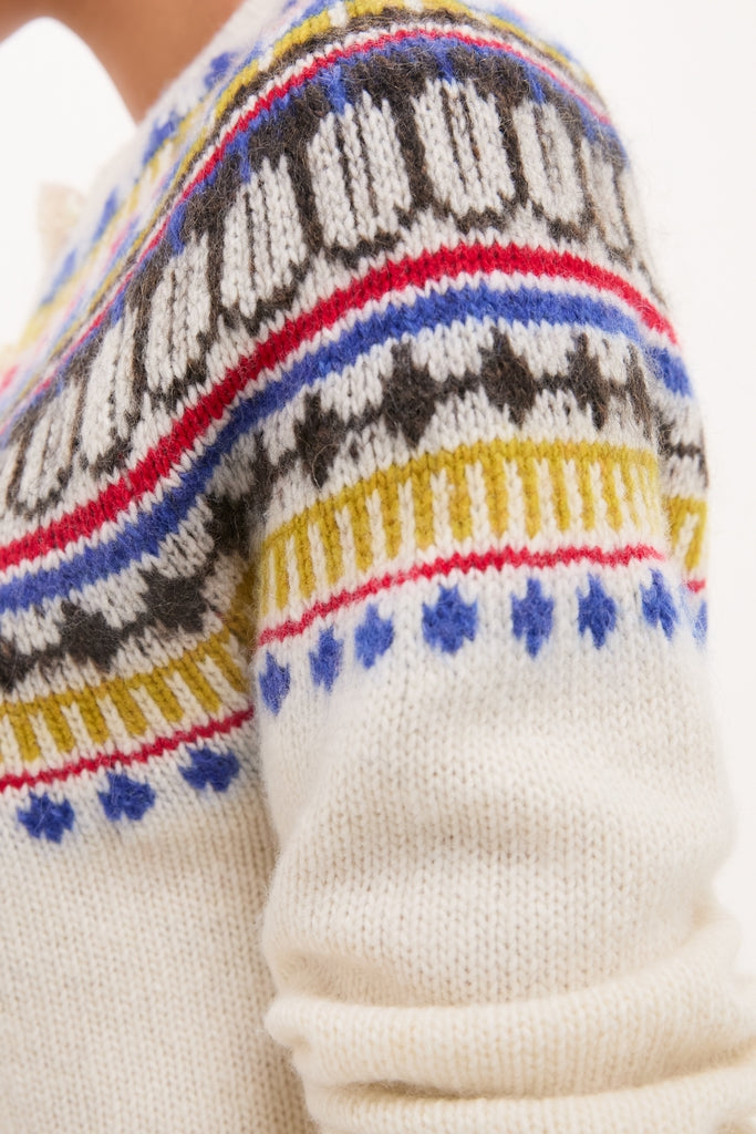 White Amina Fairisle Sweater with a classic, multi-colored geometric yoke pattern, offering an effortless, fun, and high-end style reflective of Tuckernuck's ethos.