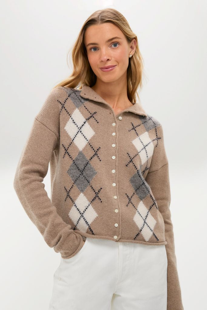 Young woman wearing the classic Oatmeal Taylor Cardigan with argyle pattern and high-waisted white pants, embodying an effortless, chic, and high-end style.