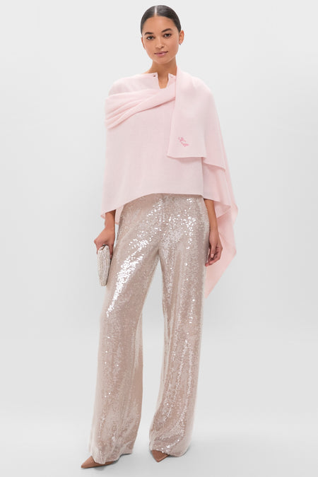 Model wearing the Ballet Slipper Cashmere Blanket Scarf, a classic, effortless wrap paired with sparkling sequin trousers and a chic evening clutch for a high-end, fun look.