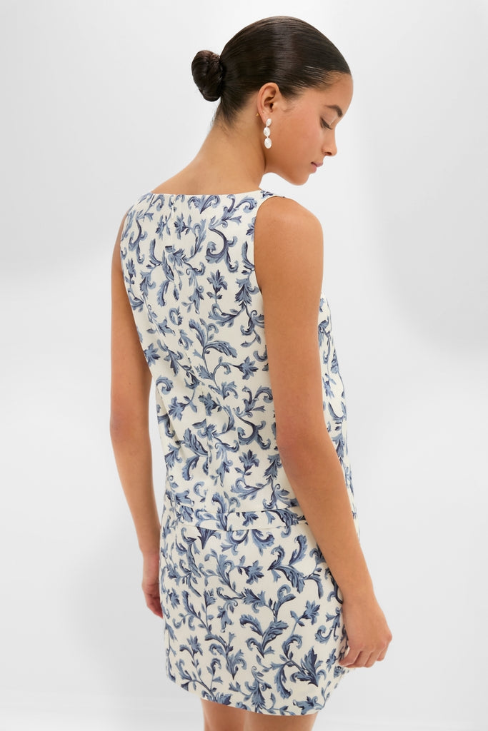 Model in classic Blue Baroque Rue Shift Mini Dress with pleat detailing and hidden pockets, exudes effortless elegance, ideal for a fun, high-end summer outing.