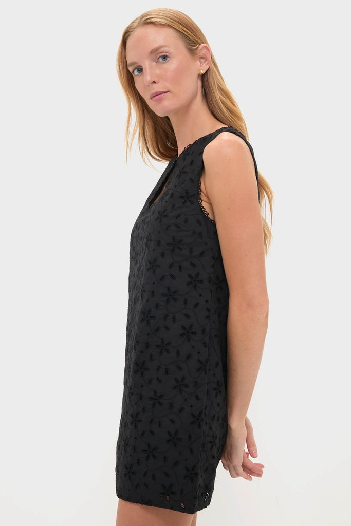 Black Salma Mini Dress: A classic, sleeveless black shift dress with an embroidered floral pattern, showcasing effortless style and high-end craftsmanship, perfect for a fun, confident look.