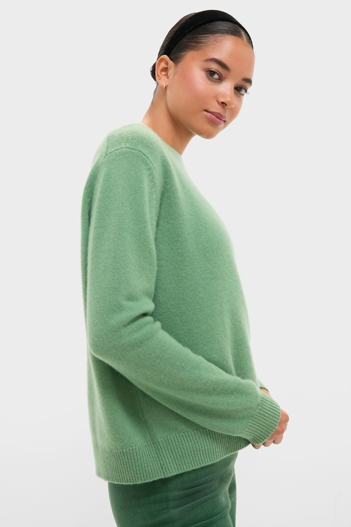 Young woman in profile wearing the Meadow Green Cashmere Boyfriend Bodie Crewneck Sweater, showcasing a classic, effortless, and high-end look.