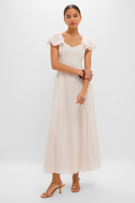 Classic Cream and Red Polka Dot Marlowe Flutter Dress with sweetheart neckline and flutter sleeves, styled effortlessly with sandals and accessories for a fun, high-end look.