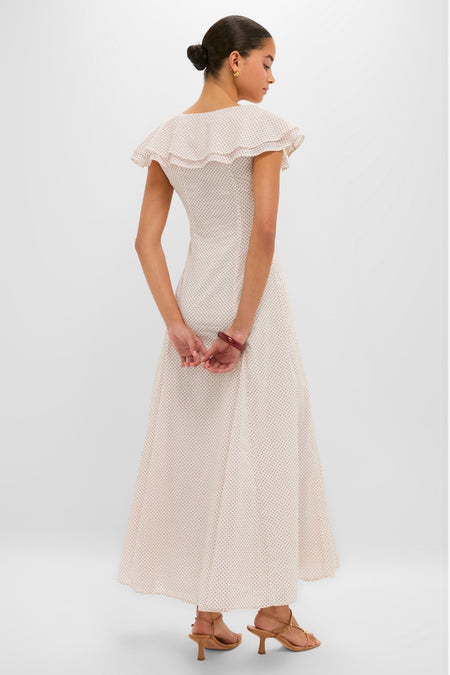 Young woman in a classic, high-end Cream and Red Polka Dot Marlowe Flutter Dress, exuding effortless style with ruffled collar and elegant accessories, embodying fun sophistication.