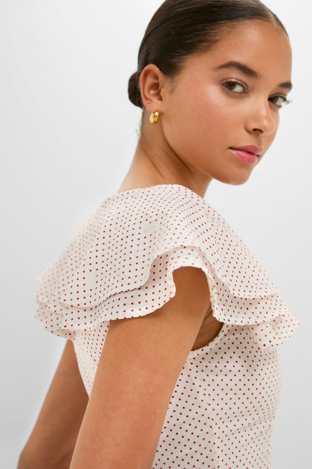 Young woman modeling the Cream and Red Polka Dot Marlowe Flutter Dress with classic ruffle details, capturing an effortless, high-end style that's perfect for fun outings.