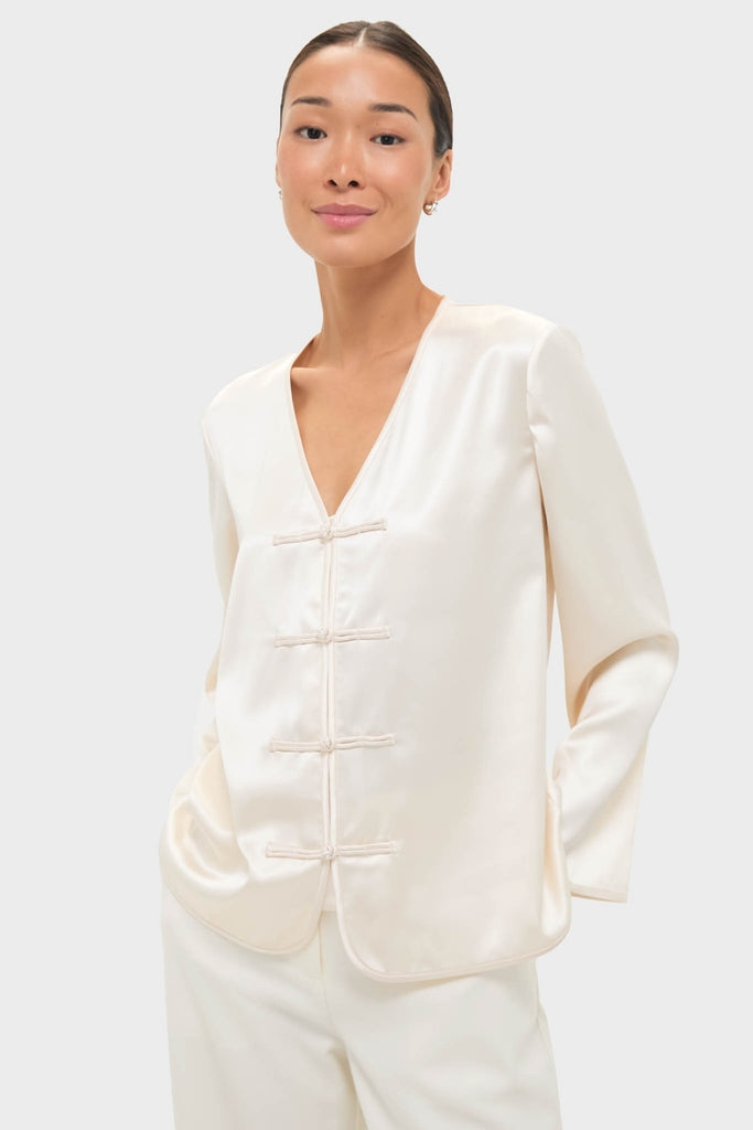 Cream Satin Tatiana Blouse with classic V-neck and chic frog closures, offering an effortless, high-end look for fun, elevated occasions.