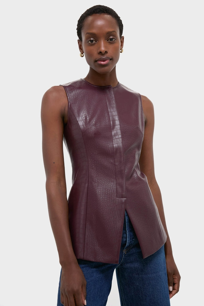 Model wears the classic, effortless Plum Stamped Faux Leather Duke Top, featuring a high-end crocodile-embossed texture and chic silhouette, paired with blue jeans for a fun, stylish look.