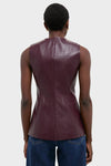 Back view of a model in the Plum Stamped Faux Leather Duke Top, showcasing its classic sleeveless design and croc-embossed texture, paired effortlessly with jeans.
