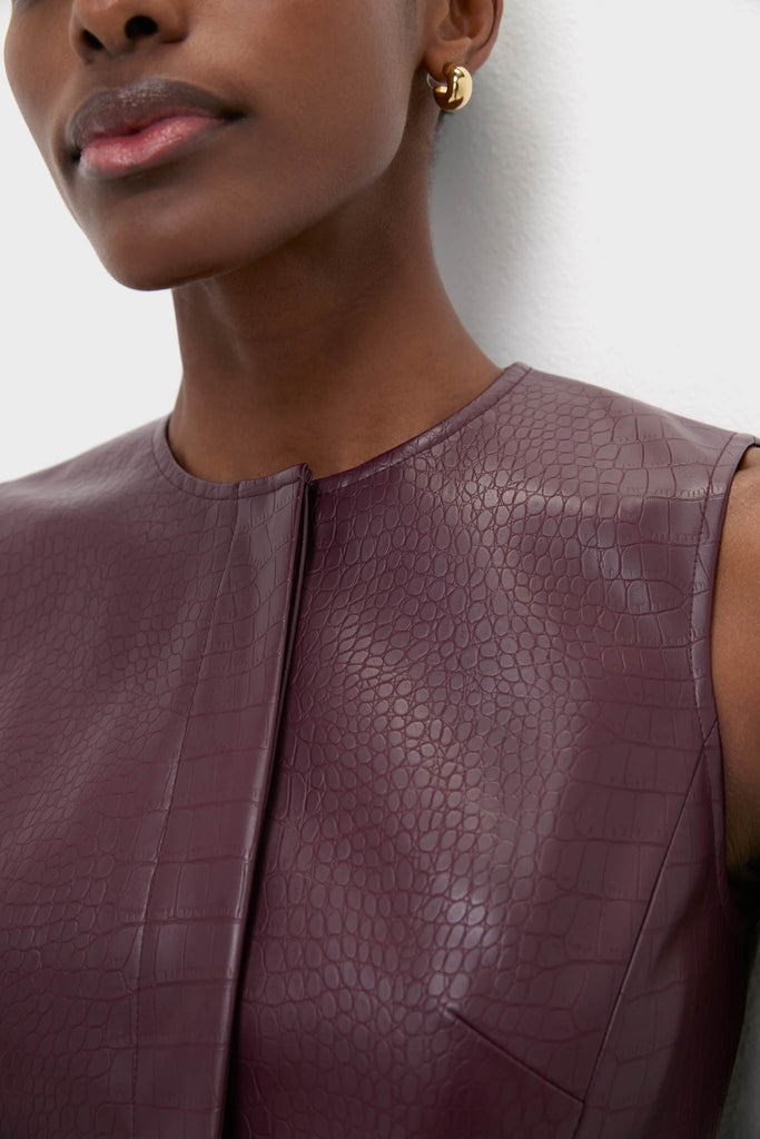 Plum Stamped Faux Leather Duke Top: A classic, sleeveless faux-leather blouse with crocodile texture, embodying effortless elegance and fun style, perfect for high-end, versatile looks.
