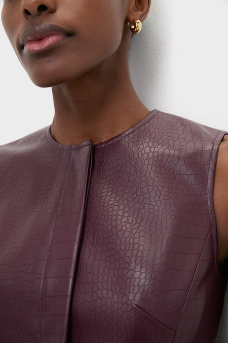 Plum Stamped Faux Leather Duke Top: A classic, sleeveless faux-leather blouse with crocodile texture, embodying effortless elegance and fun style, perfect for high-end, versatile looks.