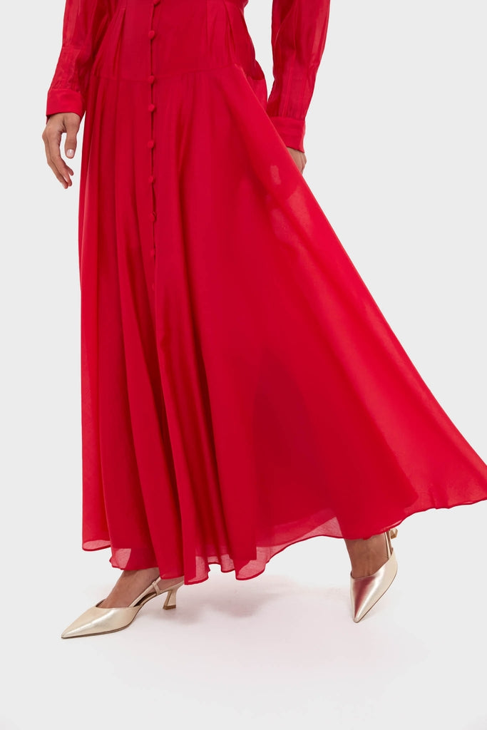 The Red Organza Marbella Dress exudes effortless elegance with its flowing design and classic front buttons, paired with high-end metallic gold slingback heels for a fun, stylish look.