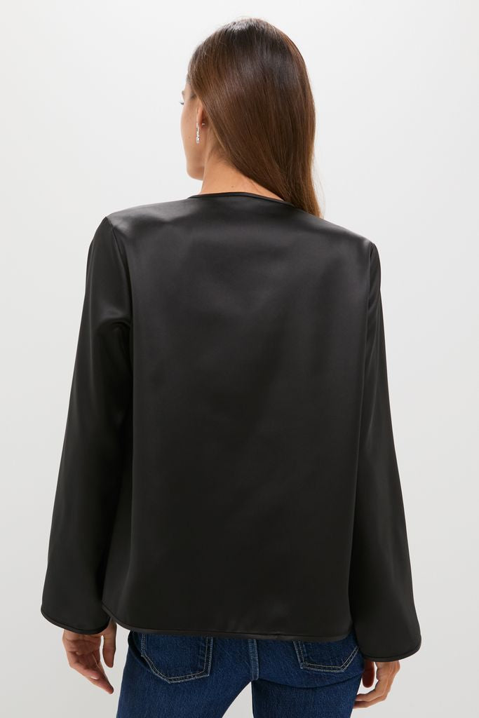 Model in classic Black Satin Tatiana Blouse with a chic finish, paired with denim jeans, showcasing an effortless, high-end look perfect for day-to-night occasions.