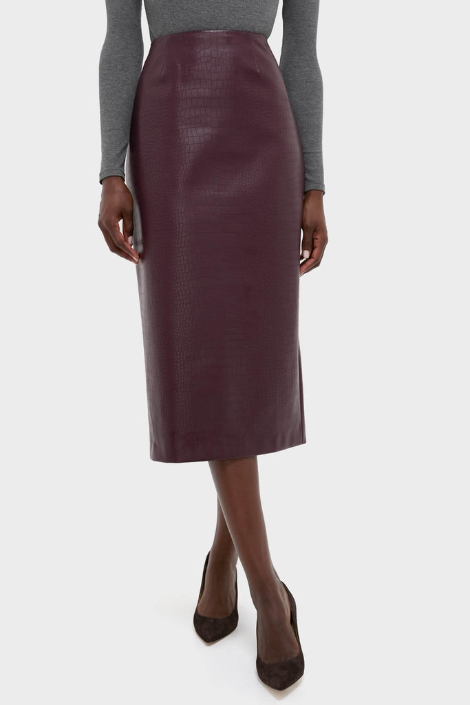 Woman wearing the classic, high-end Plum Stamped Faux Leather Ellington Skirt, showcasing its effortless croc-embossed design, styled with a fitted top and pumps.