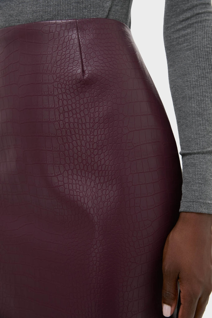 Plum Stamped Faux Leather Ellington Skirt, a classic, high-end pencil skirt, showcases effortless style with a croc-embossed texture, perfect for fun desk-to-drinks transitions.
