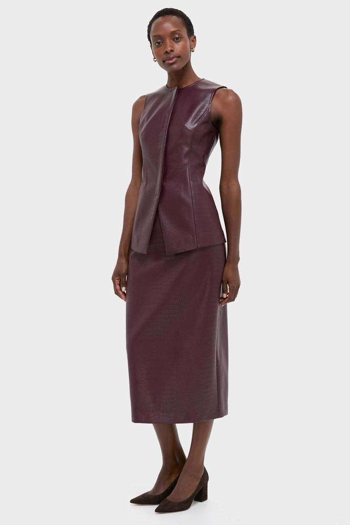 Model wearing the Plum Stamped Faux Leather Ellington Skirt, a classic, croc-embossed midi piece paired with the matching top, showcasing effortless, high-end style for versatile occasions.