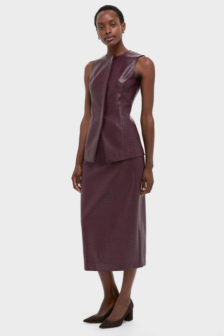 Model wearing the classic Plum Stamped Faux Leather Ellington Skirt, showcasing its effortless high-end croc-embossed design, paired with a matching flared top and block-heel pumps.