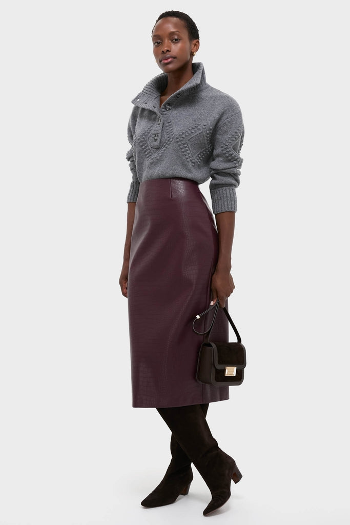 Model wearing the Plum Stamped Faux Leather Ellington Skirt paired with a chunky knit pullover, creating an effortless, high-end look with classic, fun style.