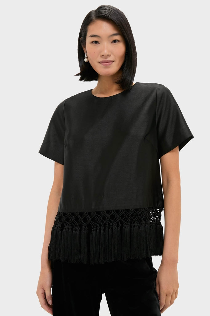 Model wearing the Black Dupioni Chadwick Tassel Top, a classic, effortless, high-end piece with a knotted fringe hem, perfect for fun, stylish occasions.