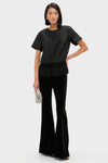 Black Dupioni Chadwick Tassel Top: Classic short-sleeve design with bold tassel hem, styled effortlessly with high-end velvet trousers and a fun beaded clutch for a confident look.