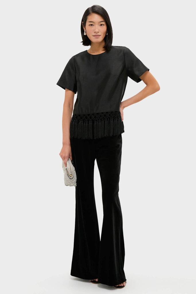 Black Dupioni Chadwick Tassel Top: Classic short-sleeve design with bold tassel hem, styled effortlessly with high-end velvet trousers and a fun beaded clutch for a confident look.