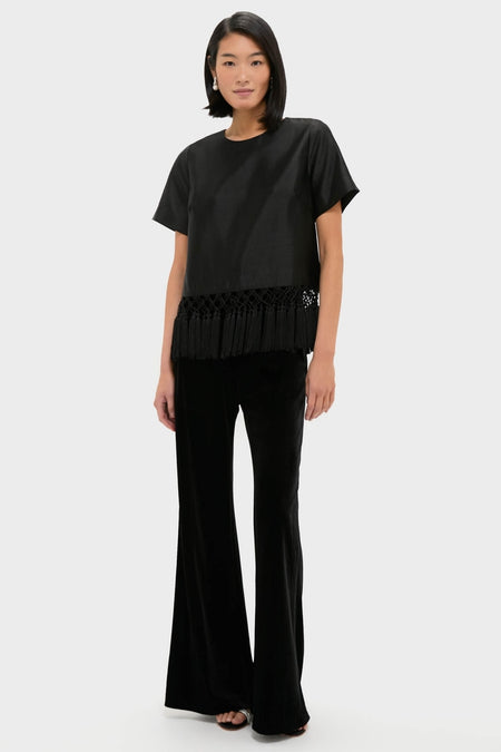 A classic, effortless Black Dupioni Chadwick Tassel Top with bold fringe hem, styled with high-end wide-leg trousers and sandals for a fun, sophisticated look.