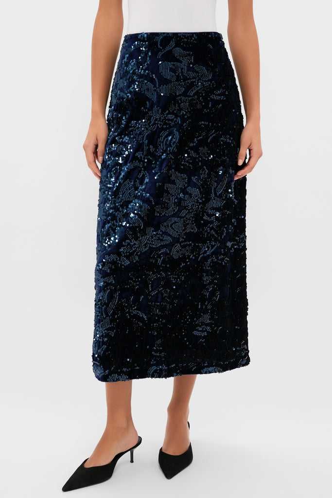 Velvet and Sequin Maloney Midi Skirt: A classic, high-end navy skirt with floral sequins, effortlessly paired with heels for a fun, chic cocktail or holiday look.