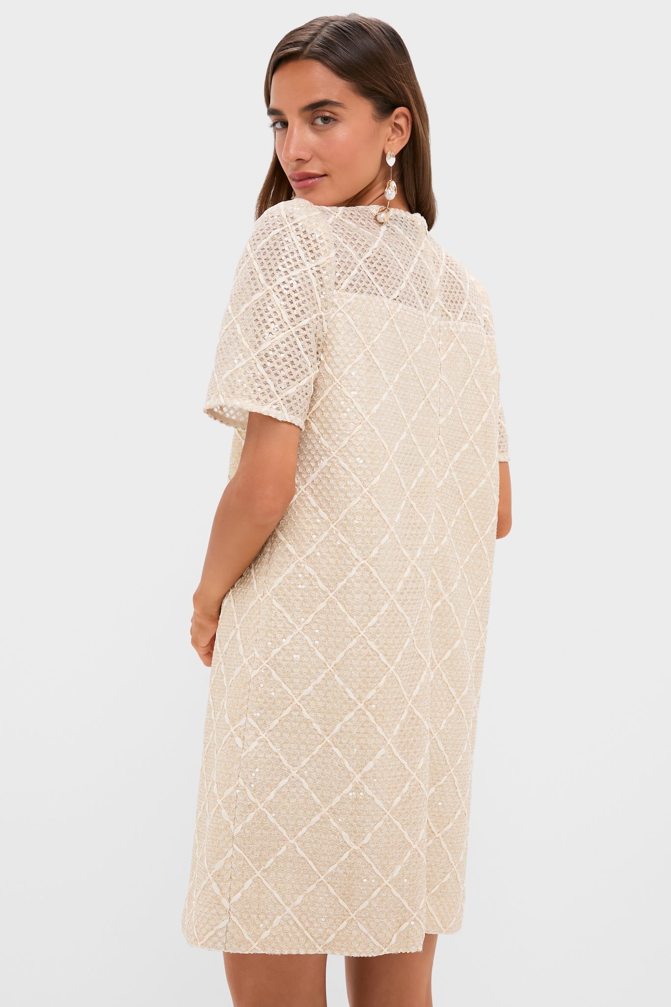 Ivory Sequin Short Sleeve Janelle Mini Dress on a woman, showcasing its classic, effortless style with sequin shimmer, puffed shoulders, and diamond-pattern texture for a high-end, fun look.