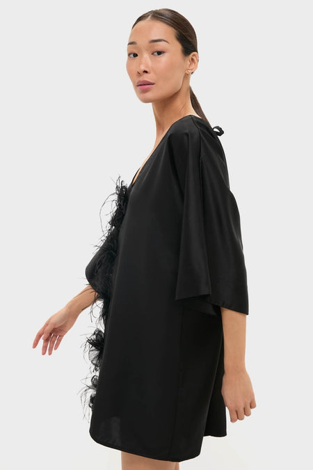 Woman wearing Black Satin Diane Mini Dress with three-quarter kimono sleeves and feather floral trim, showcasing a classic, effortless style for high-end events.