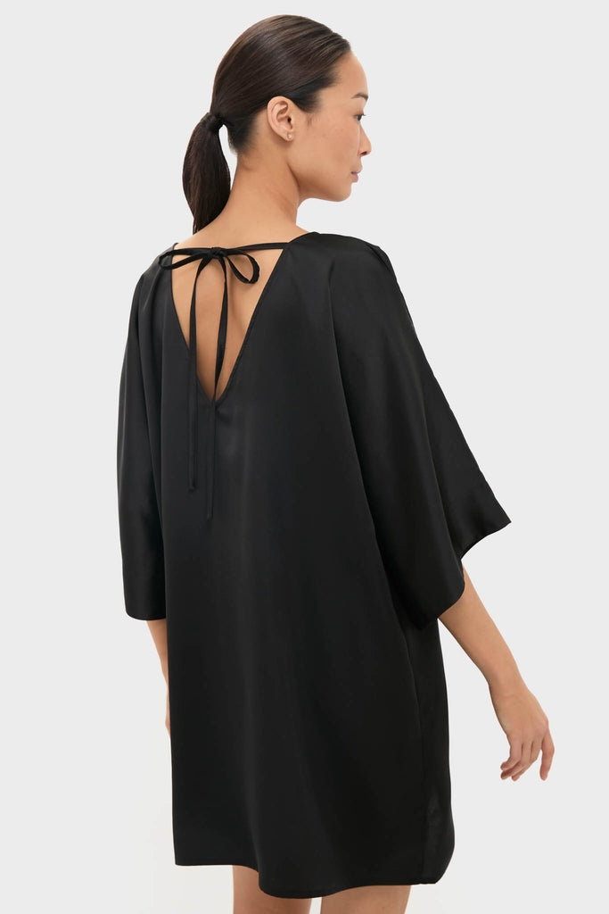 Black Satin Diane Mini Dress featuring a classic, effortless silhouette with a V-shaped back and kimono sleeves. Perfect for fun, high-end events.