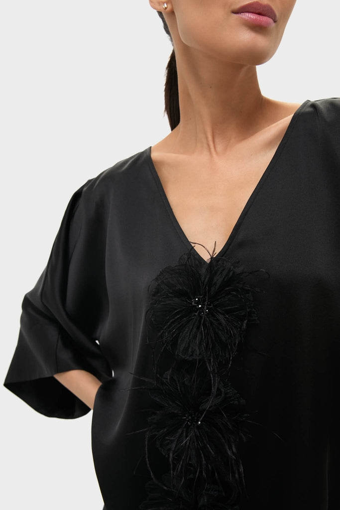 Black Satin Diane Mini Dress featuring effortless kimono sleeves and fun, high-end feather floral embellishments, embodying a classic and confident style.
