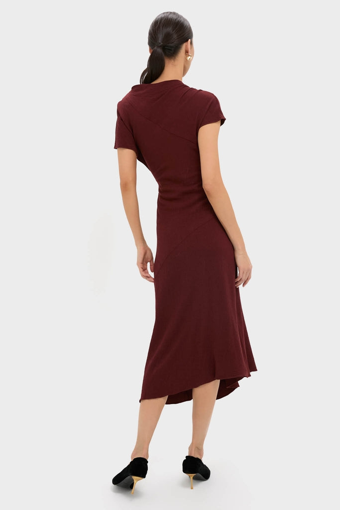 The Black Cherry Dena Midi Dress showcases classic elegance with its asymmetrical hem and ruched detailing, offering an effortless, high-end look for any special occasion.