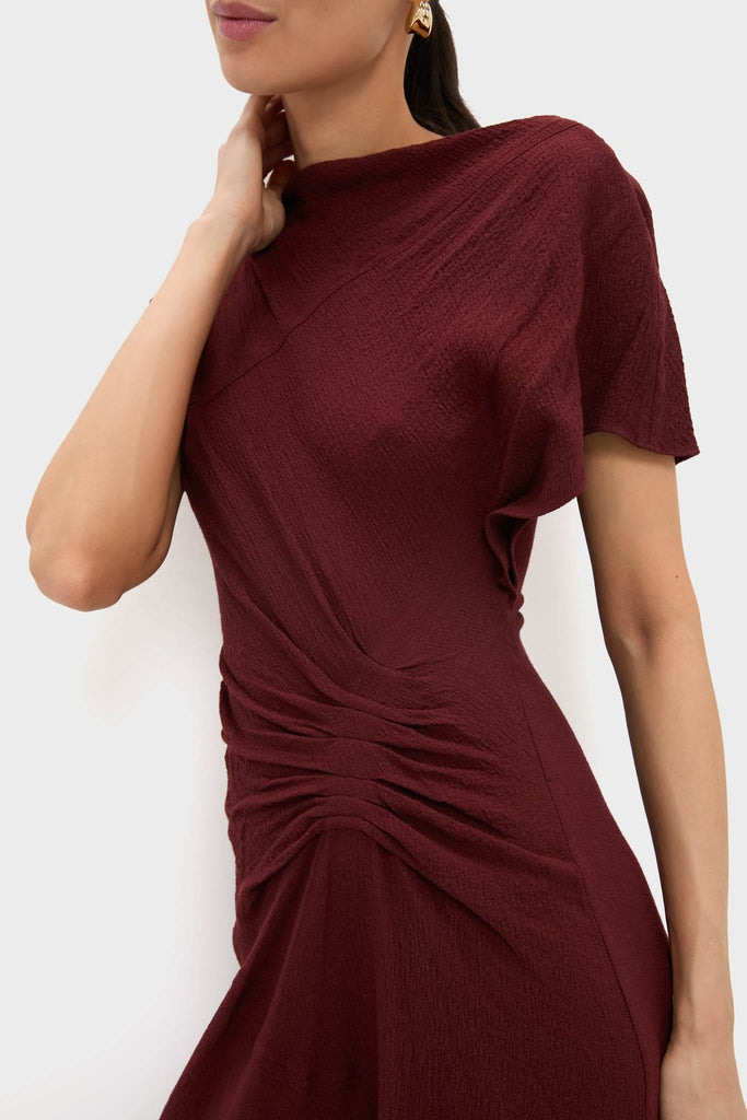 Black Cherry Dena Midi Dress with classic ruched detailing and an asymmetrical neckline, embodying effortless high-end style for any fun, special occasion.