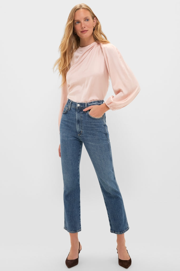 Soft Pink Blush Satin Blaire Top features classic, effortless style with gathered shoulders and blouson sleeves, paired with high-waisted jeans and pointed-toe heels for a fun, high-end look.