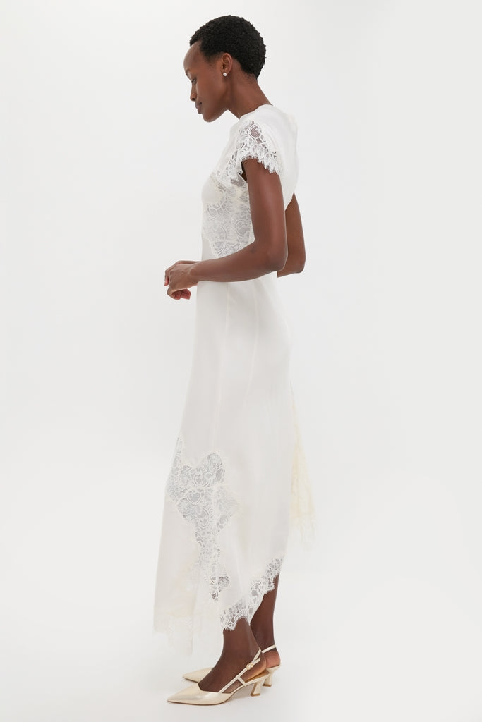 Classic and effortless, the Creme Satin Lace Alessia Midi Dress showcases elegant lace panels and a flowing skirt, paired with chic slingback shoes for a high-end, fun look.