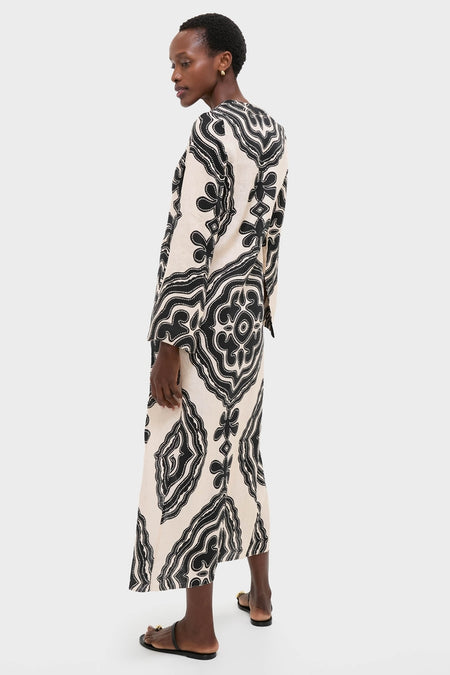 Niku Cream Theodora Column Dress on model, featuring a classic, effortless silhouette with bold patterns, long bell sleeves, and a chic V-neckline, embodying fun, high-end style.