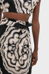 Close-up of Niku Black Sanaa Skirt in an abstract print, featuring a classic, high-waisted design with an effortless, fun self-tie belt and button-front closure.