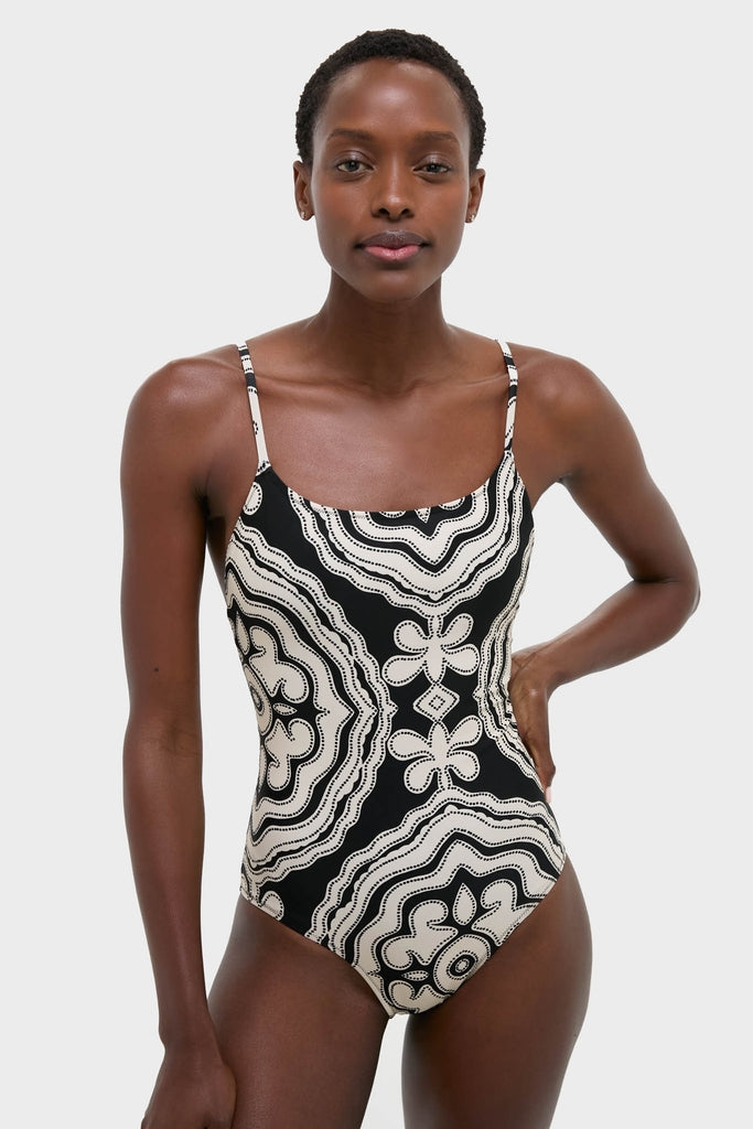 The Niku Black Elene One Piece swimsuit, featuring a classic, effortless design with an abstract pattern, adjustable straps, and a high-end, flattering silhouette.