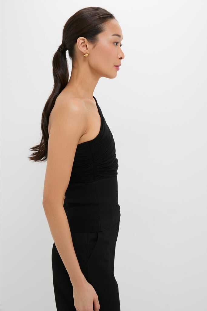 Black Satterly Top: A classic, one-shoulder, ruched bodice design paired with black trousers, exuding effortless, high-end style for a fun, confident look.